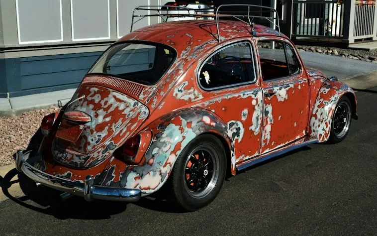 a corroded car near the coast
