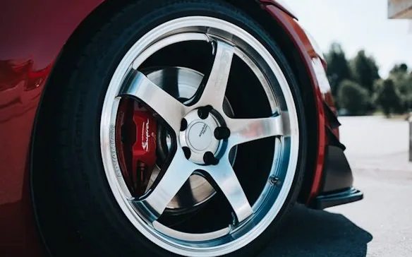 finished five-spoke wheel on a car